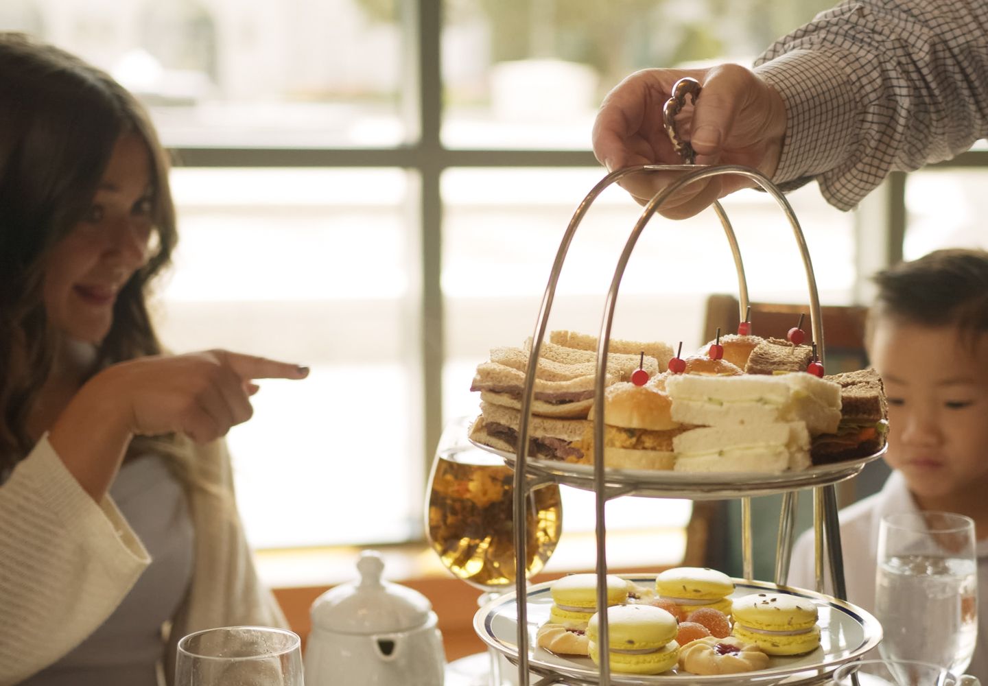 Mother and son eating tea sandwiches
