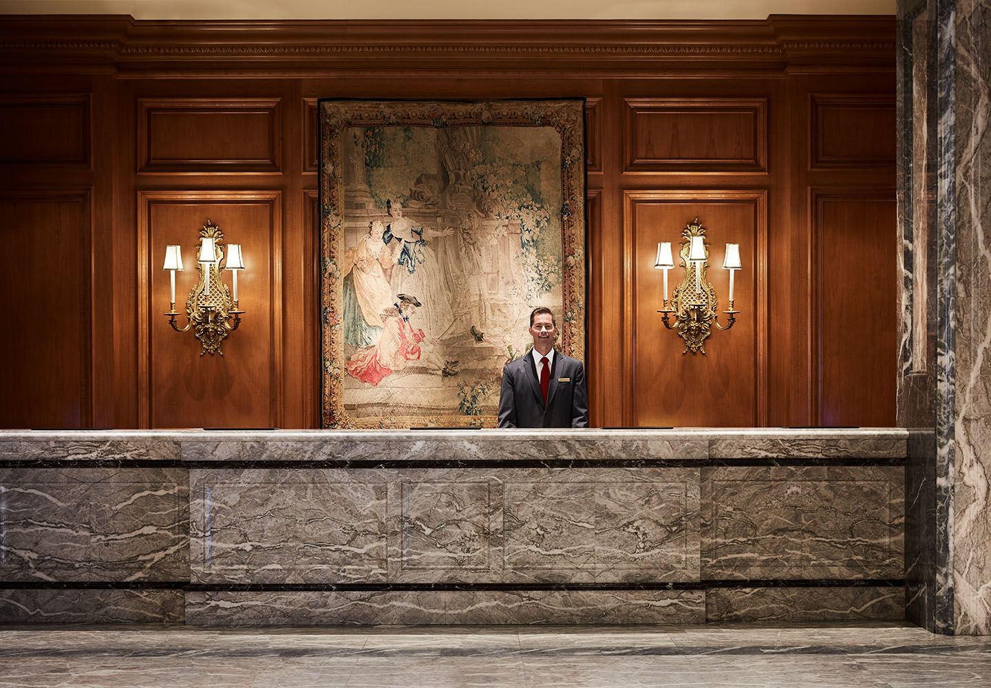 Front Desk agent with a warm smile at Front Desk in Lobby