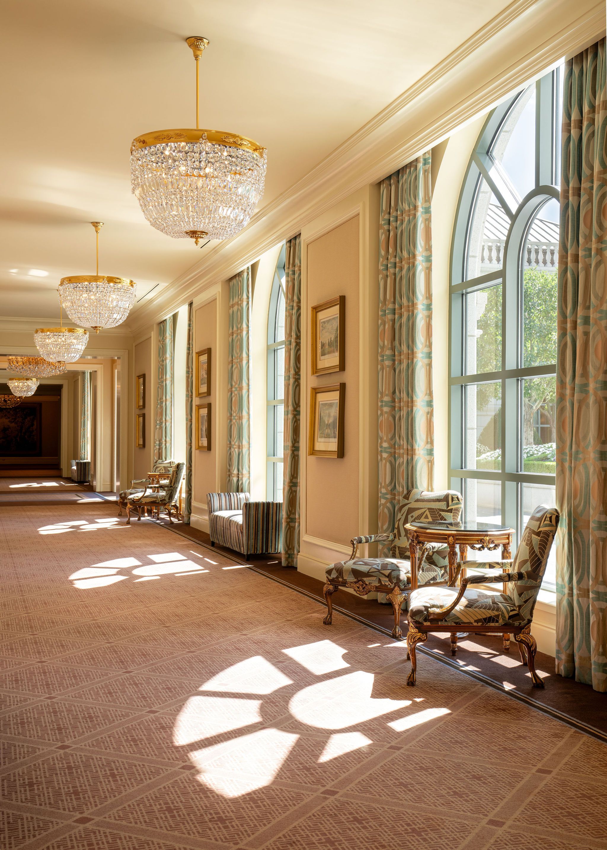 Hallway at Grand America Hotel showing beautiful windows and stunning chandelier.