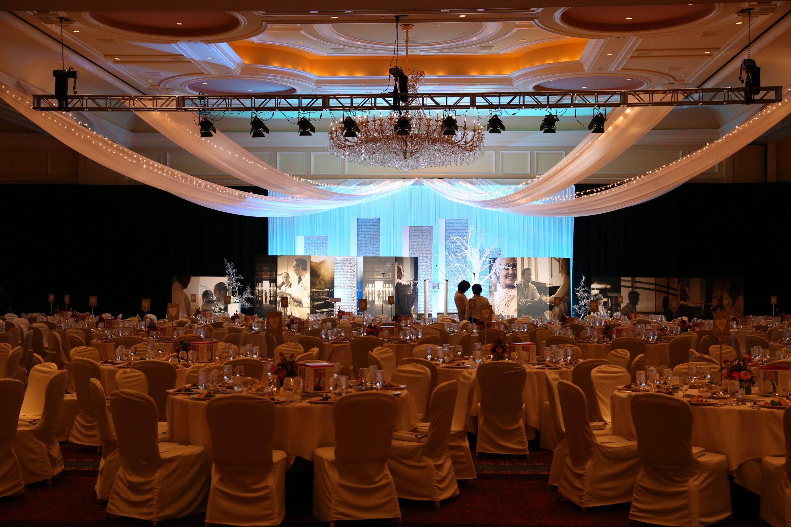 A complete event set-up complete with lighting, seating, displays, and d[[\u00e9]]cor