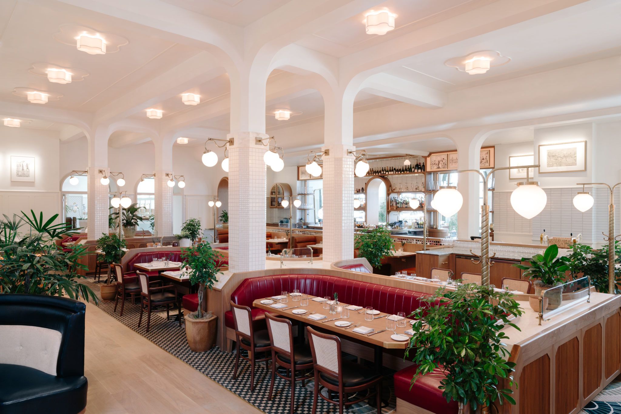 View of Laurel Brasserie & Bar dining space, showing an open guest booth and a bar in the distance.