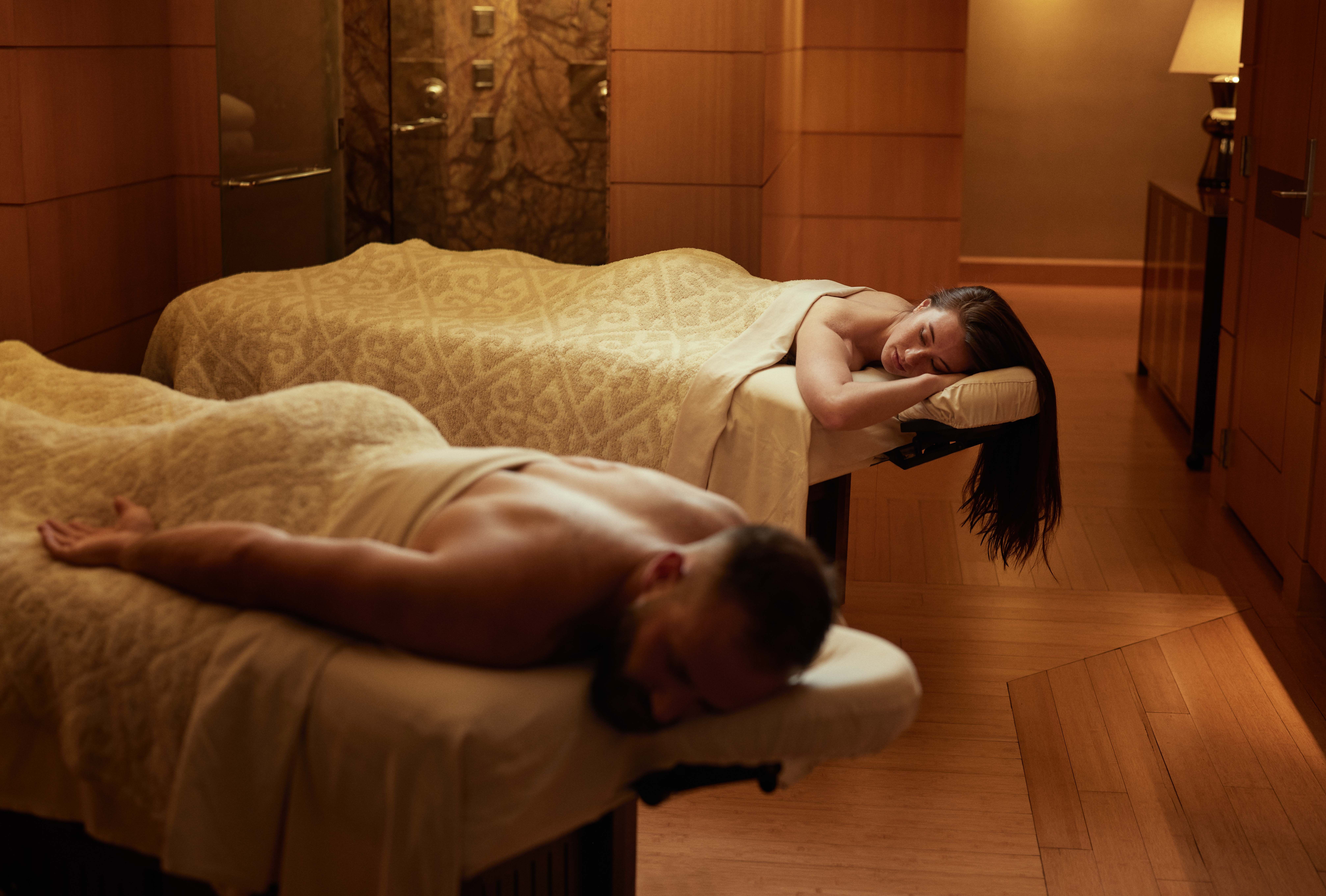 Couple laying on massage beds