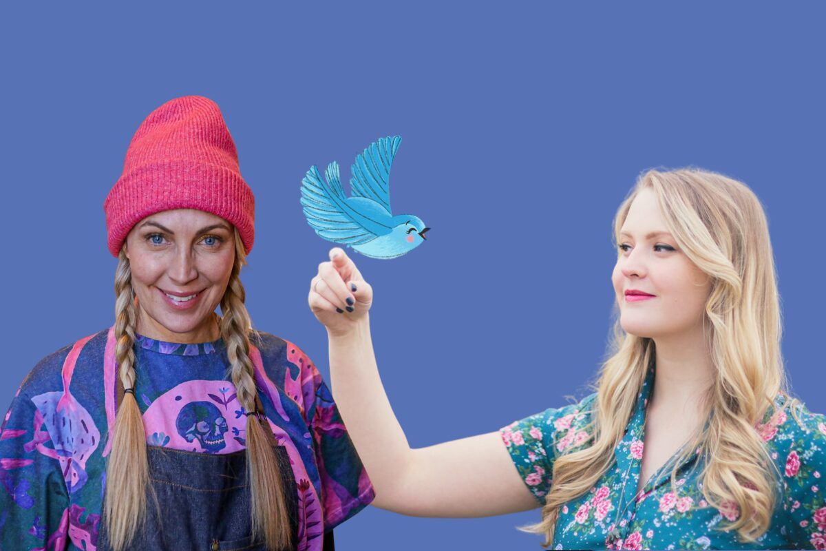 One woman wearing a pink hat and another woman holding an illustrated blue bird