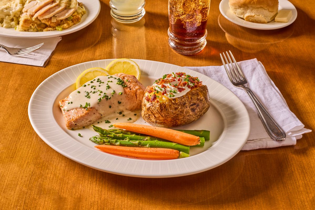 Plate of salmon, vegetables, and baked potato