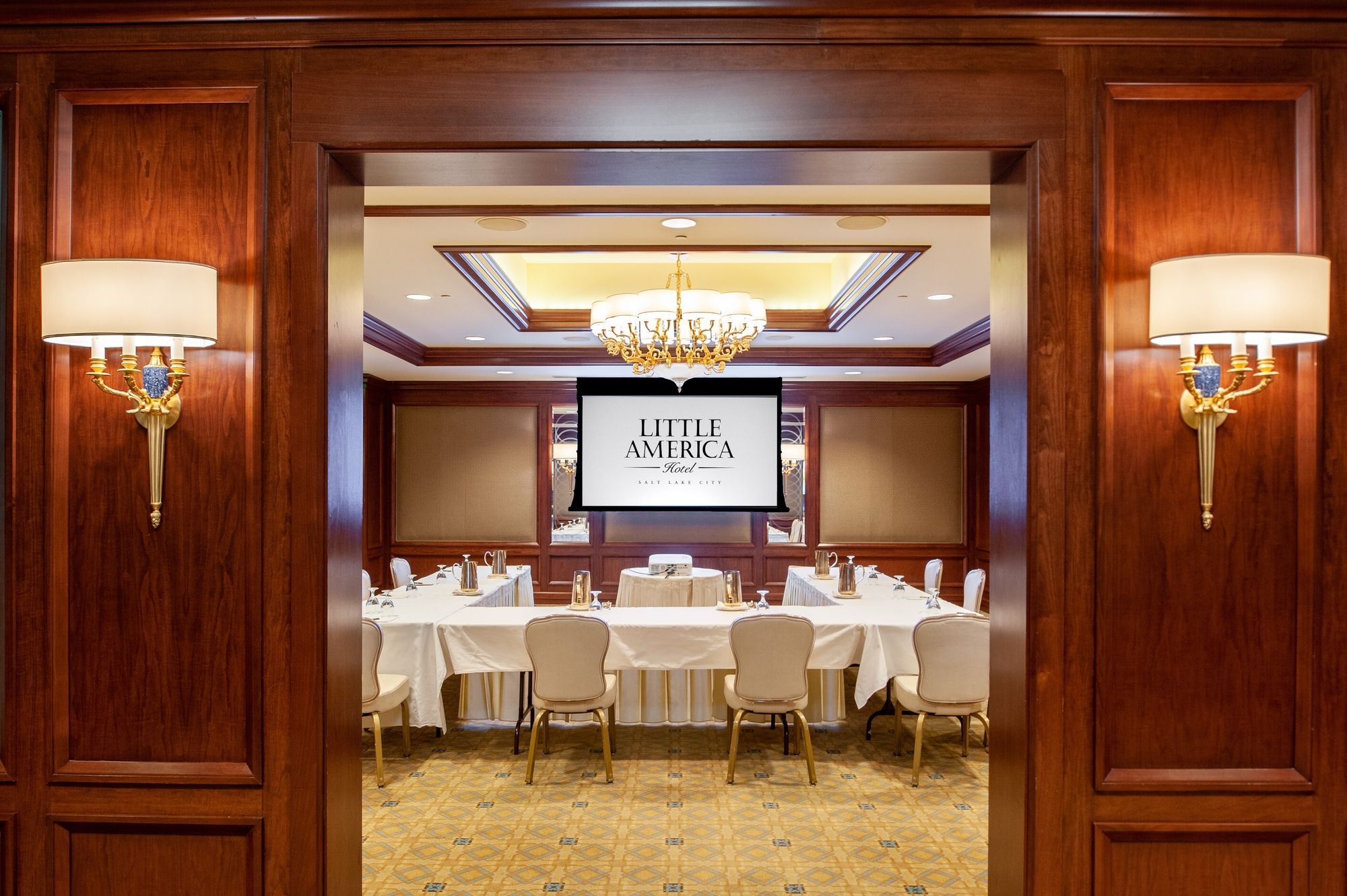 Looking through wooden doors into a Little America conference room